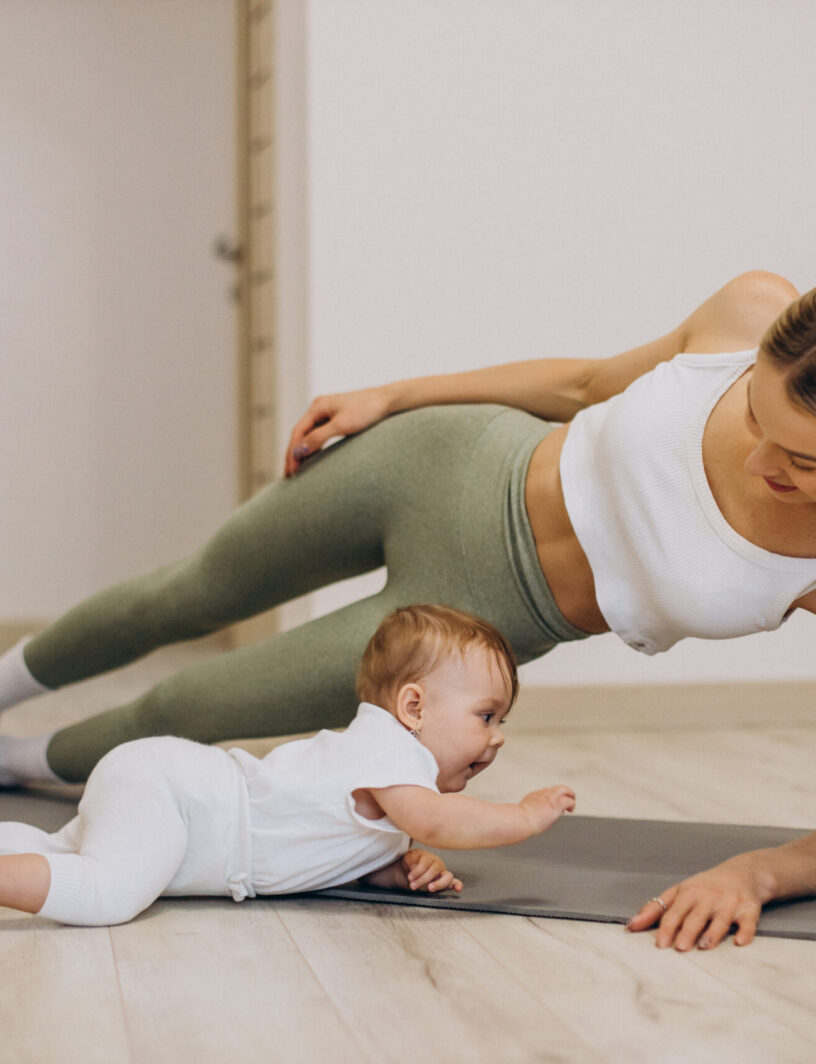 Mother practicing yoga with her baby daughter at home